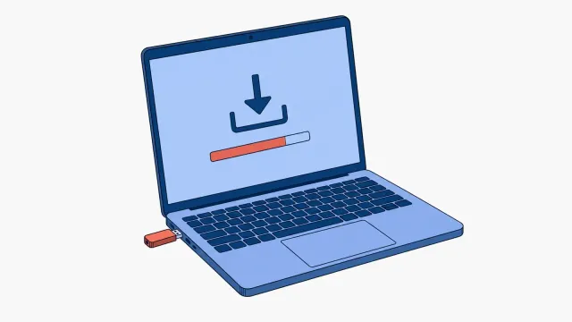 Otwarty laptop z wpiętym w boczny port koralowym pendrive'em, na ekranie ikona pobierania i pasek postępu wypełniony na koralowo w około trzech czwartych